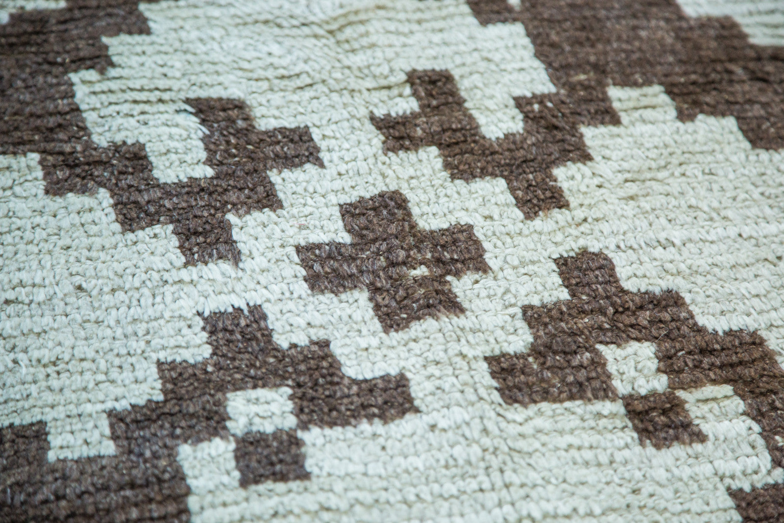 Shaggy textured Vintage Tulu rug with pale ivory and charcoal geometric pattern.